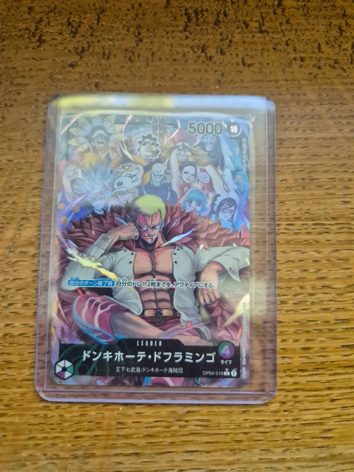 Carte Donquixote Doflamingo OP04-019_p1 Leader du set OP-04 Kingdoms of Intrigue (langue JA) — One Piece TCG édité par Bandai